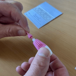 Take the lancet and twist the tip until it comes off.