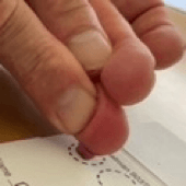 Place the blood drop in the center of the first circle on the blotting paper.